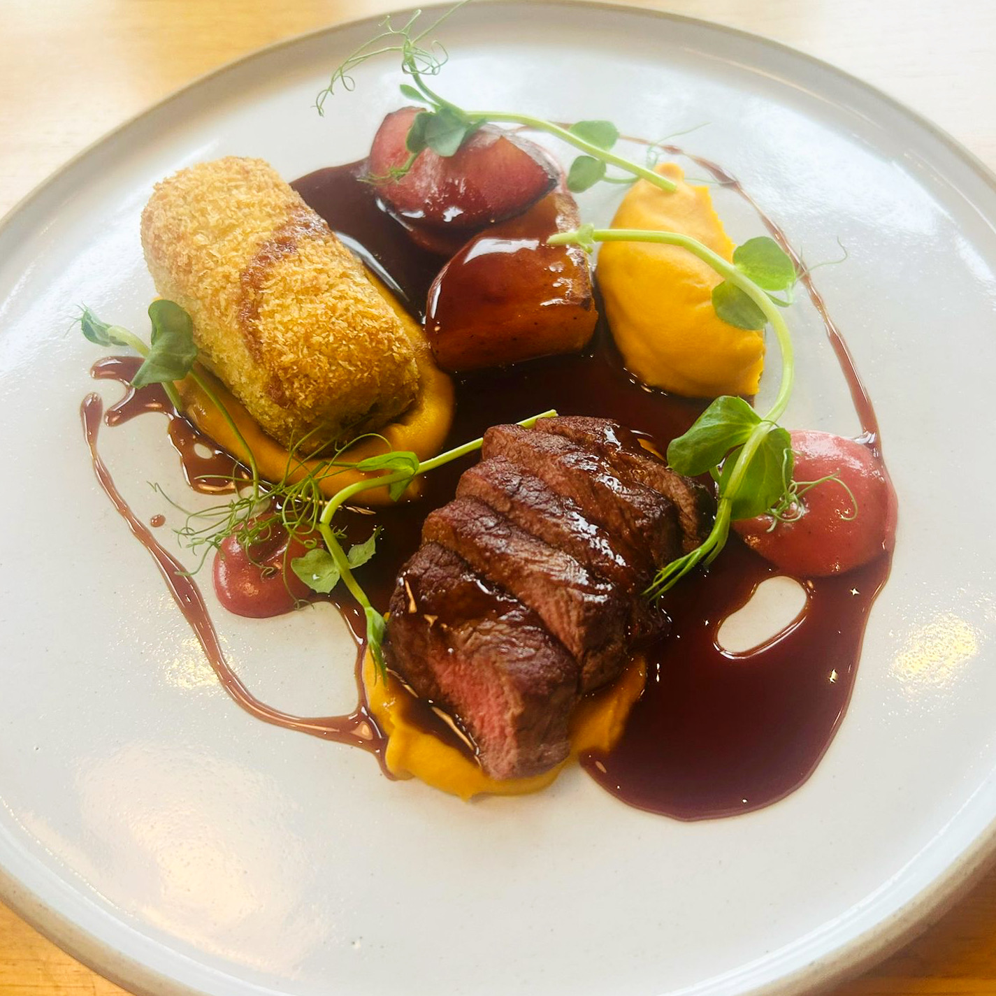 Venison loin with crispy bonbon and root vegetable purée