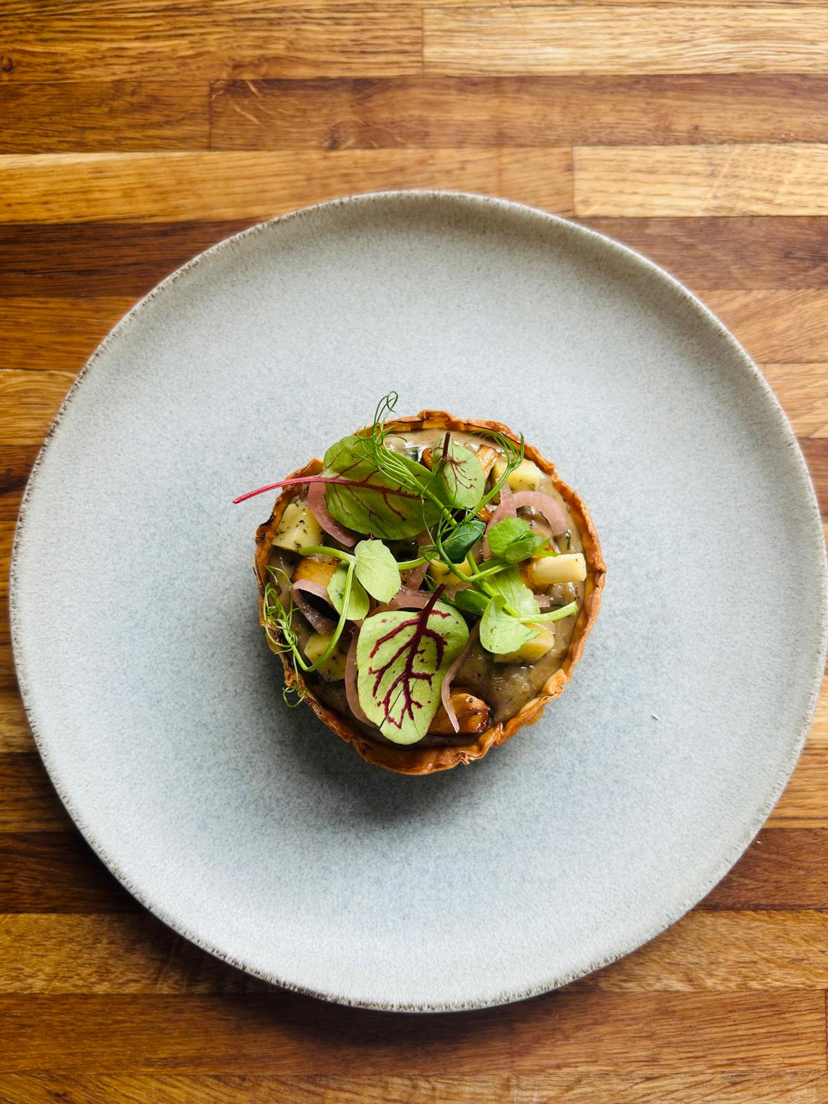 Wild mushroom tart with pickled shallot and pea shoots
